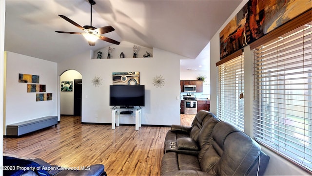 living room with ceiling fan, light hardwood / wood-style floors, and high vaulted ceiling