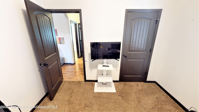 hall with light colored carpet