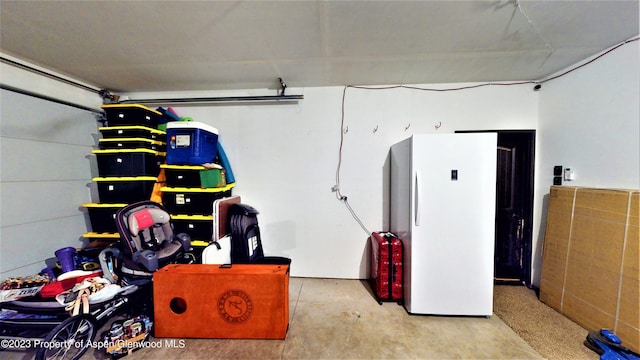 garage featuring white fridge