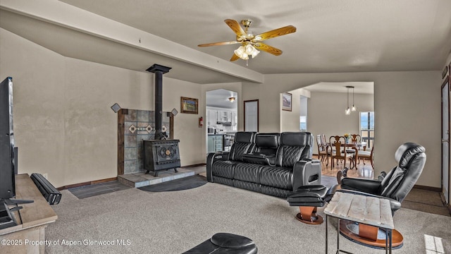 160 Mustang Mesa Trl, Rifle, CO 81650 - living room featuring ceiling fan, a wood stove, and carpet flooring