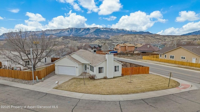 view of front of property featuring a mountain view and a garage