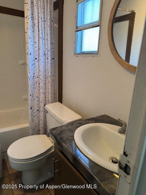 bathroom featuring tile patterned flooring, toilet, vanity, and shower / bathtub combination with curtain