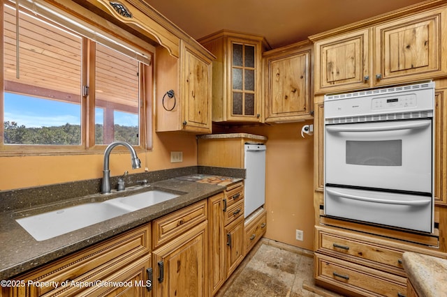 701/700 Bella Vista Ln, Cotopaxi, CO 81223 - kitchen featuring oven, a warming drawer, a sink, dark stone countertops, and glass insert cabinets