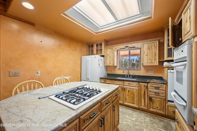 701/700 Bella Vista Ln, Cotopaxi, CO 81223 - kitchen with a sink, a warming drawer, white appliances, glass insert cabinets, and brown cabinetry