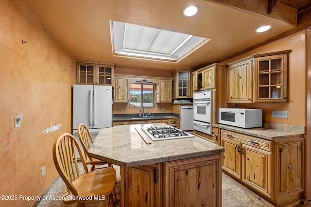 701/700 Bella Vista Ln, Cotopaxi, CO 81223 - kitchen featuring white appliances, a sink, a warming drawer, a kitchen island, and glass insert cabinets