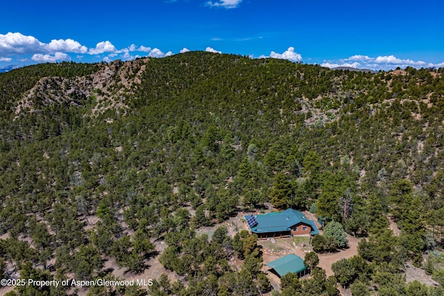 701/700 Bella Vista Ln, Cotopaxi, CO 81223 - aerial view of property and surrounding area featuring a heavily wooded area and a mountain backdrop
