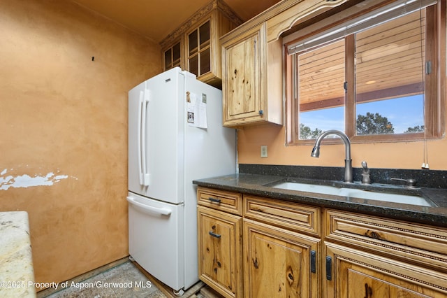 701/700 Bella Vista Ln, Cotopaxi, CO 81223 - kitchen with freestanding refrigerator, a sink, brown cabinets, dark stone countertops, and glass insert cabinets