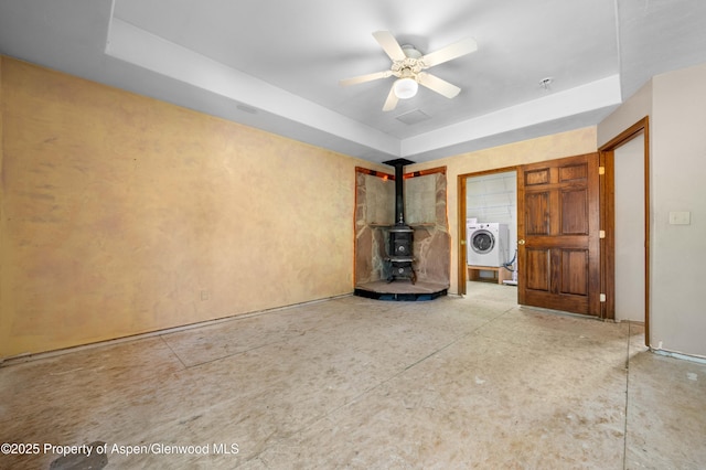 701/700 Bella Vista Ln, Cotopaxi, CO 81223 - unfurnished living room featuring a wood stove, washer / dryer, a ceiling fan, and a raised ceiling