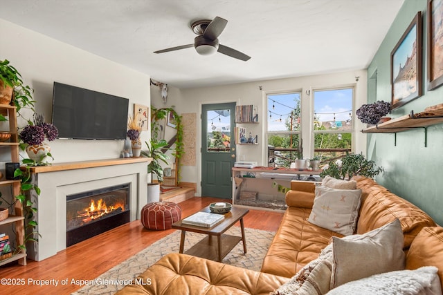 106 Lakeside Ct, Basalt, CO 81621 - living room with wood finished floors, a glass covered fireplace, and ceiling fan