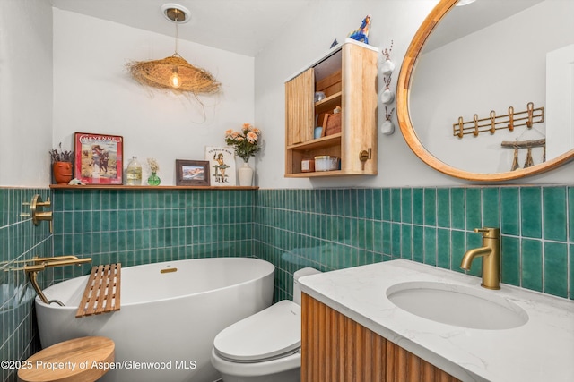 106 Lakeside Ct, Basalt, CO 81621 - full bathroom with tile walls, a soaking tub, vanity, and a wainscoted wall