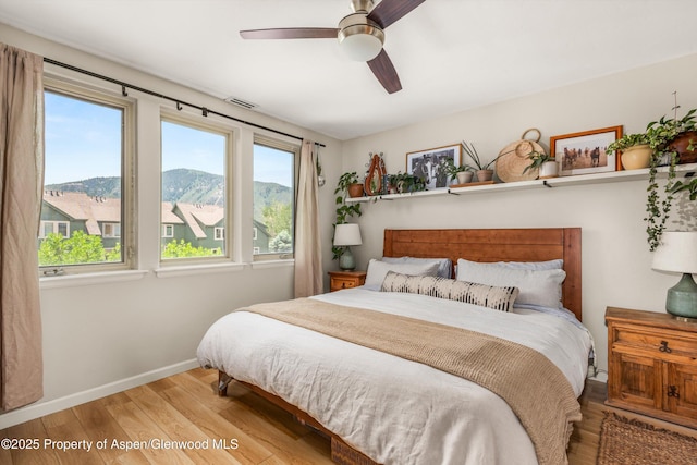 106 Lakeside Ct, Basalt, CO 81621 - bedroom with wood finished floors, a mountain view, and a ceiling fan
