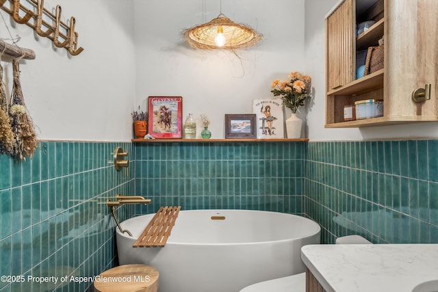 106 Lakeside Ct, Basalt, CO 81621 - full bath with tile walls, a soaking tub, a wainscoted wall, and vanity