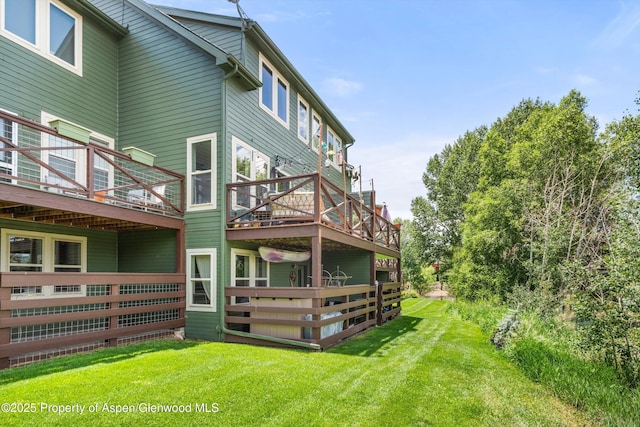 106 Lakeside Ct, Basalt, CO 81621 - back of property featuring a wooden deck and a lawn