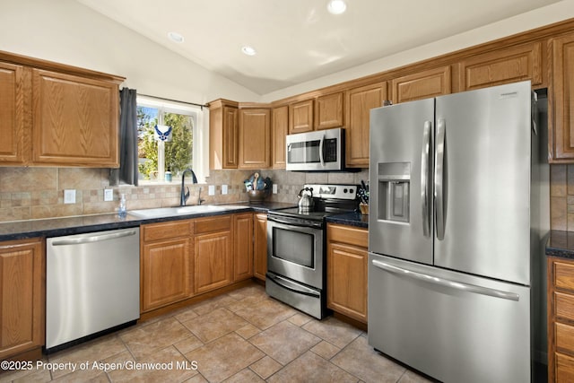 120 Harris Ln, Parachute, CO 81635 - kitchen with vaulted ceiling, stainless steel appliances, and decorative backsplash