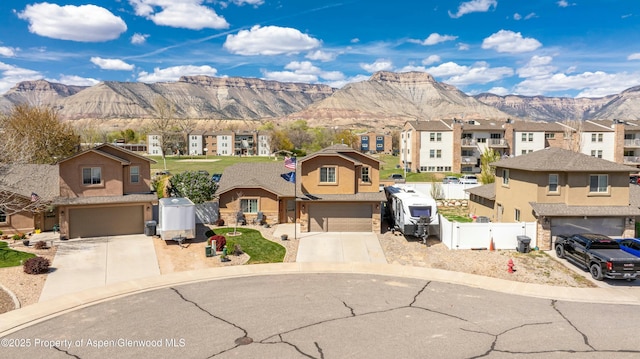 120 Harris Ln, Parachute, CO 81635 - view of front facade featuring a residential view, a mountain view, a garage, and fence