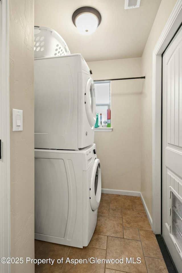 120 Harris Ln, Parachute, CO 81635 - clothes washing area with stacked washer and dryer, visible vents, laundry area, and baseboards