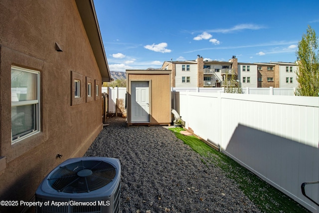 120 Harris Ln, Parachute, CO 81635 - view of yard with an outdoor structure, a fenced backyard, a storage unit, central AC unit, and a residential view