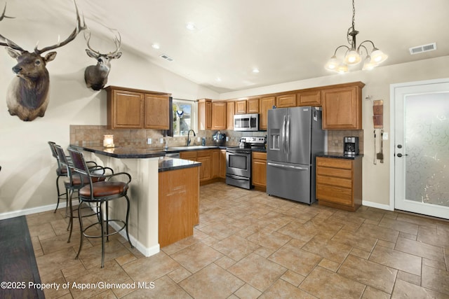 120 Harris Ln, Parachute, CO 81635 - kitchen with appliances with stainless steel finishes, tasteful backsplash, visible vents, and a peninsula