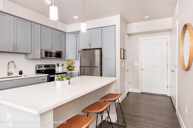 253 Wulfsohn Rd Unit 318, Glenwood Springs, CO 81601 - kitchen with appliances with stainless steel finishes, a sink, gray cabinets, baseboards, and light countertops