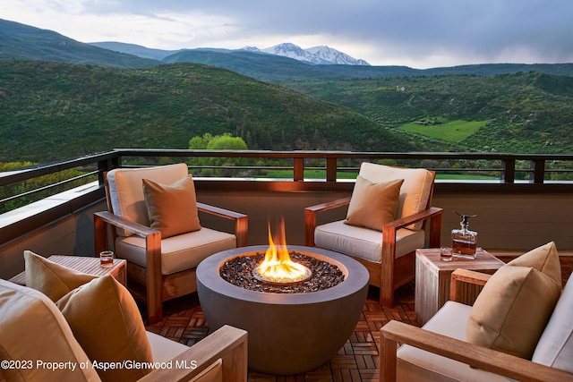 deck featuring a mountain view and an outdoor fire pit