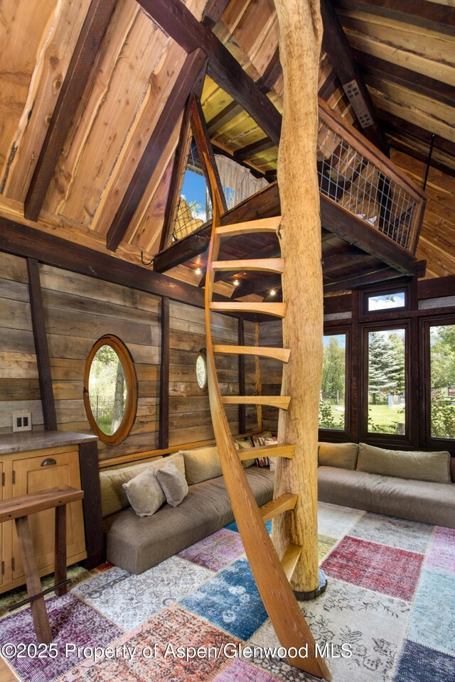 2701 County Rd 100, Carbondale, CO 81623 - stairs with wood walls, wooden ceiling with exposed beams, and high vaulted ceiling
