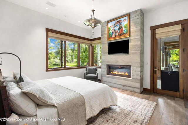 2701 County Rd 100, Carbondale, CO 81623 - bedroom with hardwood / wood-style flooring, a fireplace, and recessed lighting
