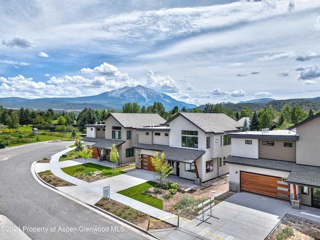 view of front of home featuring a mountain view and a garage