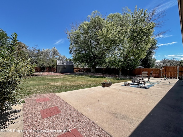 560 Willowwood Ln, Delta, CO 81416 - fenced backyard with a storage shed, a patio, and a fire pit