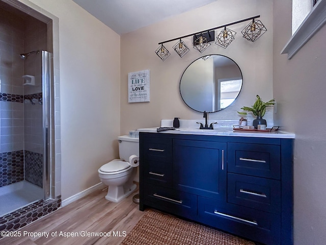 560 Willowwood Ln, Delta, CO 81416 - bathroom with wood finished floors, vanity, and a stall shower