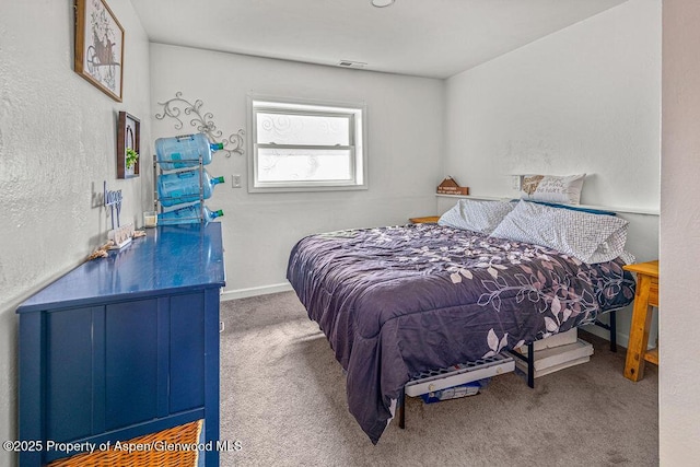carpeted bedroom featuring baseboards