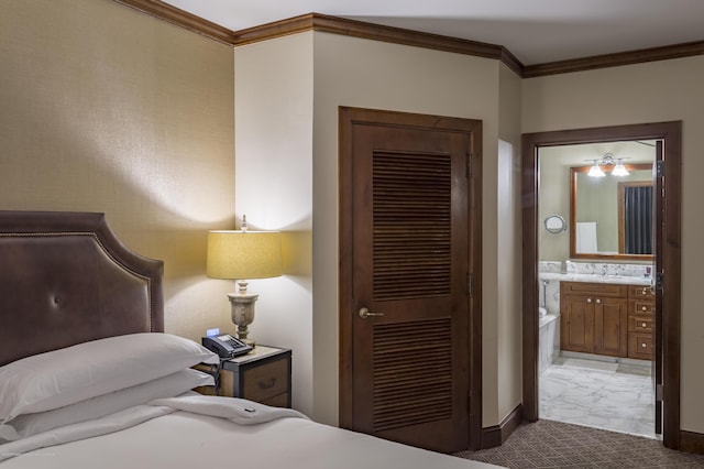 bedroom featuring ensuite bathroom, crown molding, and a closet