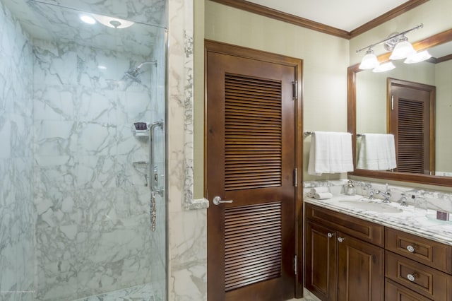 bathroom with vanity, a shower with door, and crown molding