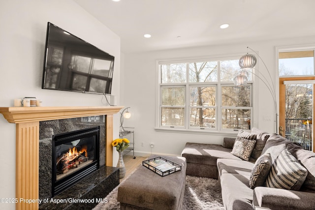 living room with a premium fireplace and a healthy amount of sunlight