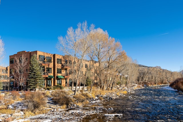 view of building exterior with a water and mountain view