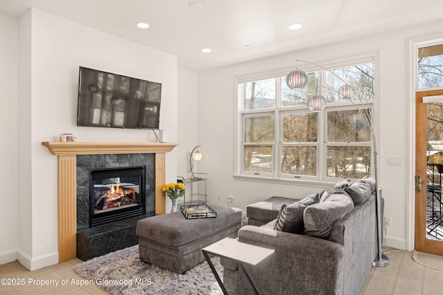 living room featuring a premium fireplace