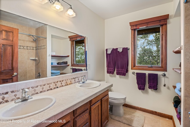 bathroom with tile patterned flooring, vanity, toilet, and backsplash