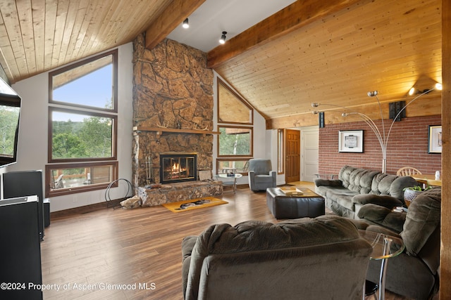 living room with beamed ceiling, plenty of natural light, wood ceiling, and high vaulted ceiling