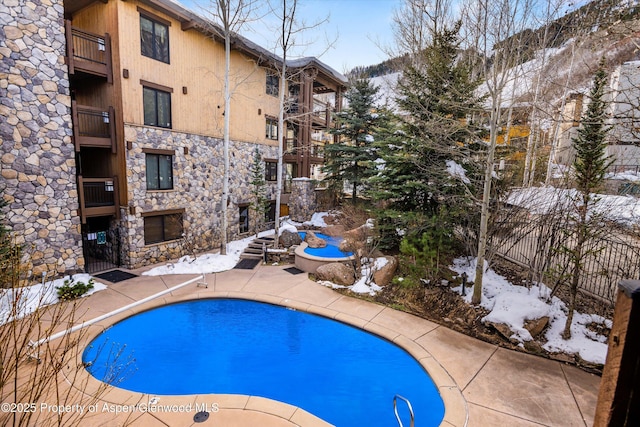 131 E Durant Ave Unit 104, Aspen, CO 81611 - snow covered pool featuring a patio area