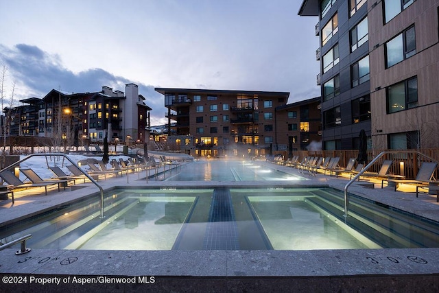 view of pool at dusk