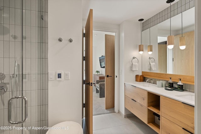 bathroom featuring tile patterned flooring, vanity, and an enclosed shower