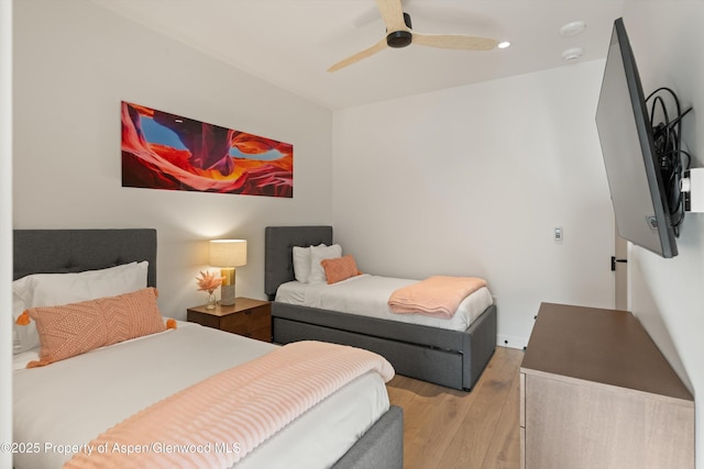 bedroom with ceiling fan and light wood-type flooring