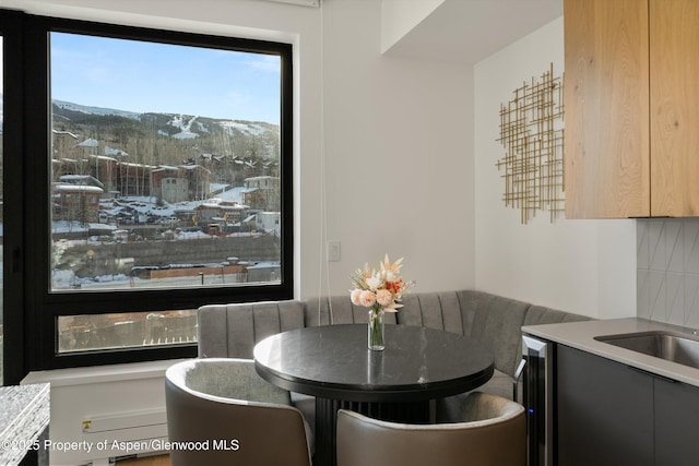 dining space with a mountain view and beverage cooler