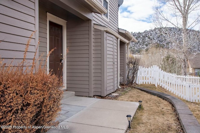 view of exterior entry with fence