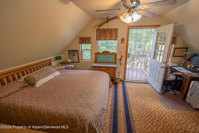 carpeted bedroom featuring access to exterior, vaulted ceiling, and ceiling fan