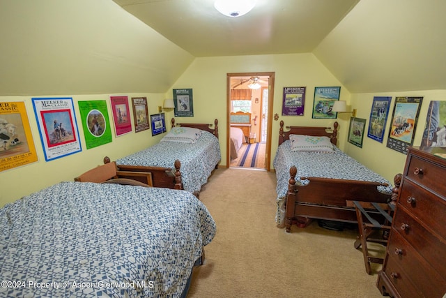 carpeted bedroom with vaulted ceiling