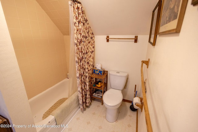 bathroom with shower / bath combo, toilet, and lofted ceiling