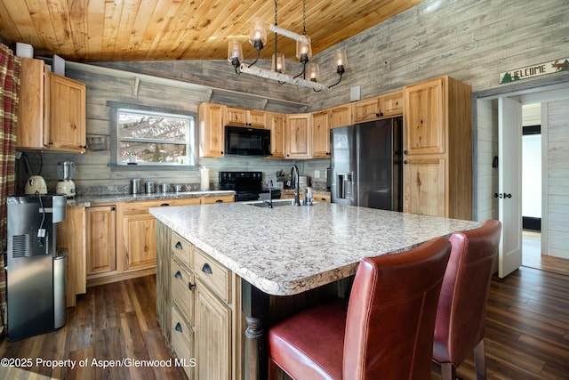 kitchen with dark wood-style flooring, lofted ceiling, wood ceiling, a sink, and black appliances