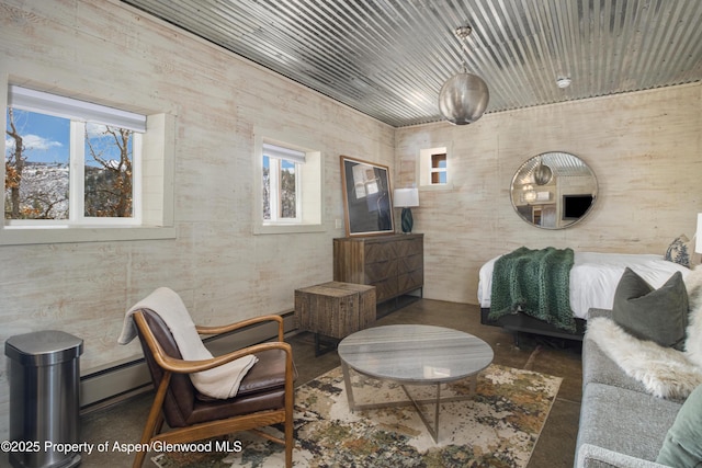 living area with wooden ceiling, finished concrete flooring, and baseboard heating