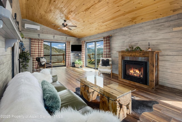 living room featuring a warm lit fireplace, wooden ceiling, an AC wall unit, and wood finished floors