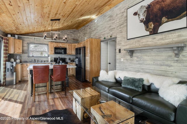 living area featuring lofted ceiling, wood ceiling, and wood finished floors